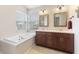 Bright bathroom featuring a soaking tub, double sinks, and large vanity at 10441 Alexia Dr, Indianapolis, IN 46236