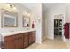 Bright bathroom featuring double sinks, wooden cabinets, walk-in shower, and walk-in closet at 10441 Alexia Dr, Indianapolis, IN 46236