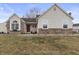 Charming home with a combination of siding and brickwork and well-maintained lawn at 10441 Alexia Dr, Indianapolis, IN 46236