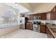 Bright kitchen with stainless steel appliances, tile floors, and lots of natural light at 10441 Alexia Dr, Indianapolis, IN 46236