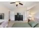 Cozy main bedroom with a ceiling fan and adjacent bathroom and vanity at 10441 Alexia Dr, Indianapolis, IN 46236