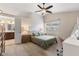 Inviting primary bedroom with a ceiling fan, plush carpet, and natural light at 10441 Alexia Dr, Indianapolis, IN 46236