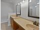 Bathroom featuring dual sinks, framed mirrors, and a vanity for storage at 11134 Westoves Dr, Noblesville, IN 46060