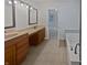 Primary bathroom featuring double sinks, vanity, soaking tub, and ceramic tile floors at 11134 Westoves Dr, Noblesville, IN 46060