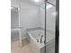 Bathroom showcasing a soaking tub with tile surround and glass-enclosed shower at 11134 Westoves Dr, Noblesville, IN 46060
