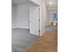 Bright bedroom with light gray walls, neutral carpet, and hardwood flooring in the hallway at 11134 Westoves Dr, Noblesville, IN 46060