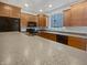 Well-equipped kitchen featuring wood cabinets, granite countertops, and modern appliances at 11134 Westoves Dr, Noblesville, IN 46060