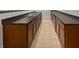 Spacious laundry room with stainless steel sink, dark countertop, and wooden cabinets at 11134 Westoves Dr, Noblesville, IN 46060