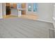 Open-concept living room showcasing hardwood floors flowing into a kitchen and dining area at 11134 Westoves Dr, Noblesville, IN 46060