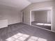 A bright bedroom featuring an open layout with plush gray carpeting at 1155 Dark Star Ct, Whiteland, IN 46184