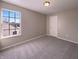 A cozy bedroom featuring a window, ceiling light, and plush carpeting at 1155 Dark Star Ct, Whiteland, IN 46184