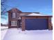 Charming two-story brick home with a blue garage door and well-maintained lawn at 1155 Dark Star Ct, Whiteland, IN 46184