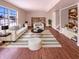 Bright living room featuring hardwood floors, a large window, and stylish modern furniture at 1155 Dark Star Ct, Whiteland, IN 46184
