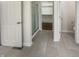 Hallway view of a bright bathroom featuring tile floors, shower, toilet, and closet at 12036 Weathered Edge Dr, Fishers, IN 46037