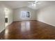 Bright bedroom featuring high ceilings, hardwood floors, a ceiling fan, and a window at 12036 Weathered Edge Dr, Fishers, IN 46037