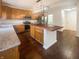 Eat-in kitchen with hardwood floors, wood cabinets, granite countertops, stainless steel appliances, and kitchen island at 12036 Weathered Edge Dr, Fishers, IN 46037