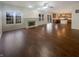 Spacious living room with hardwood floors, fireplace, neutral paint, and natural light from large windows at 12036 Weathered Edge Dr, Fishers, IN 46037