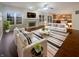Bright and open living room featuring a fireplace, hardwood floors, neutral paint, and large windows at 12036 Weathered Edge Dr, Fishers, IN 46037