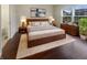 Cozy bedroom with hardwood floors, a large window with natural light, and modern decor at 12036 Weathered Edge Dr, Fishers, IN 46037