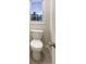 Close up view of a toilet with window in the bathroom at 12036 Weathered Edge Dr, Fishers, IN 46037
