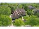 Aerial shot of a brick and siding home surrounded by lush greenery, manicured lawns, and mature trees in a neighborhood setting at 13133 Brooks Landing Pl, Carmel, IN 46033