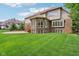 Spacious backyard with a manicured lawn, featuring an outdoor patio and wooden deck, complemented by the home's exterior at 13133 Brooks Landing Pl, Carmel, IN 46033