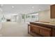 Basement with a dry bar and white built in shelving surrounding a fireplace at 13133 Brooks Landing Pl, Carmel, IN 46033