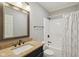 Elegant bathroom featuring a granite vanity, tile floors, and a bathtub with a white shower curtain at 13133 Brooks Landing Pl, Carmel, IN 46033