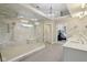 Bathroom boasts a glass shower, white cabinets, and elegant light fixtures at 13133 Brooks Landing Pl, Carmel, IN 46033