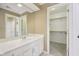 Bathroom featuring a long vanity and access to a walk-in closet and enclosed shower, blending convenience and privacy at 13133 Brooks Landing Pl, Carmel, IN 46033