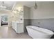 Relaxing bathroom featuring a freestanding tub, large mirror, neutral colors and chandelier at 13133 Brooks Landing Pl, Carmel, IN 46033