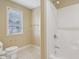 Bathroom with a shower/tub combo and window, offering a bright and efficient space for personal care at 13133 Brooks Landing Pl, Carmel, IN 46033