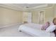 Open bedroom features a tray ceiling and access to other rooms, enhancing connectivity and flow within the home at 13133 Brooks Landing Pl, Carmel, IN 46033