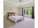 Bright bedroom with a ceiling fan, large windows for natural light, and neutral tones creating a serene environment at 13133 Brooks Landing Pl, Carmel, IN 46033