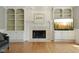 Close-up of the fireplace with built-in shelving, mantle, and mounted TV at 13133 Brooks Landing Pl, Carmel, IN 46033