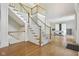 Inviting foyer featuring hardwood floors, a grand staircase, and views into adjacent living spaces at 13133 Brooks Landing Pl, Carmel, IN 46033