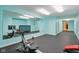 Bright workout room boasting ample mirror space, rubber flooring, and modern exercise equipment at 13133 Brooks Landing Pl, Carmel, IN 46033