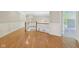 Spacious hallway with wood floors, white wainscoting, and open views, allowing for easy movement between rooms at 13133 Brooks Landing Pl, Carmel, IN 46033