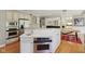 Modern kitchen island with stainless steel oven and sink in a bright, open layout at 13133 Brooks Landing Pl, Carmel, IN 46033