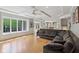 Open living room area with tray ceiling, hardwood floors, and access to kitchen at 13133 Brooks Landing Pl, Carmel, IN 46033