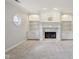 Living room with fireplace, built-in shelving, light gray carpet and neutral paint at 13133 Brooks Landing Pl, Carmel, IN 46033
