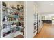 Walk-in pantry featuring ample shelving for organized storage in this home at 13133 Brooks Landing Pl, Carmel, IN 46033