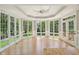 Sunroom with bay windows, tray ceiling, and French doors, offering ample natural light at 13133 Brooks Landing Pl, Carmel, IN 46033