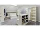 Walk-in closet with custom shelving, built-in storage, and gray carpet at 13133 Brooks Landing Pl, Carmel, IN 46033