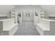 Walk-in closet with built-in storage and gray carpet at 13133 Brooks Landing Pl, Carmel, IN 46033