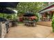Expansive backyard with outdoor kitchen, seating area, lush landscaping, and beautiful pergola at 1320 N New Jersey St, Indianapolis, IN 46202