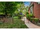 Lush backyard with iron fence, garden, stone path, flowers, and manicured lawn at 1320 N New Jersey St, Indianapolis, IN 46202