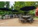 Spacious backyard features an outdoor kitchen, dining area, and mature trees for shade at 1320 N New Jersey St, Indianapolis, IN 46202