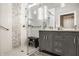 Well-lit bathroom featuring a glass-enclosed shower with bench, and a gray double vanity sink at 1320 N New Jersey St, Indianapolis, IN 46202