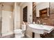 Bathroom with a white vanity, stone wall accents and a walk-in shower at 1320 N New Jersey St, Indianapolis, IN 46202